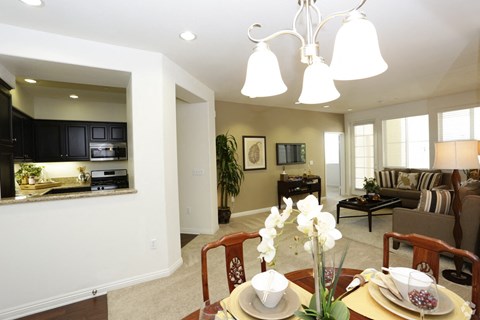 a dining room and living room with a table and chairs